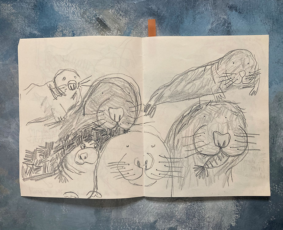 Sketchbook page of smiling hand drawn seals