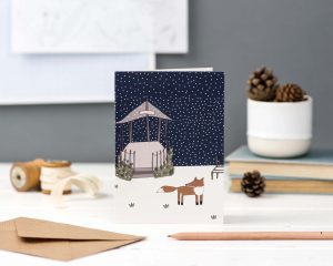 Hand illustrated greeting card of a fox outside in the snow for christmas